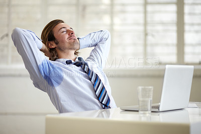 Buy stock photo A young businessman with sweat stains under his arms at work