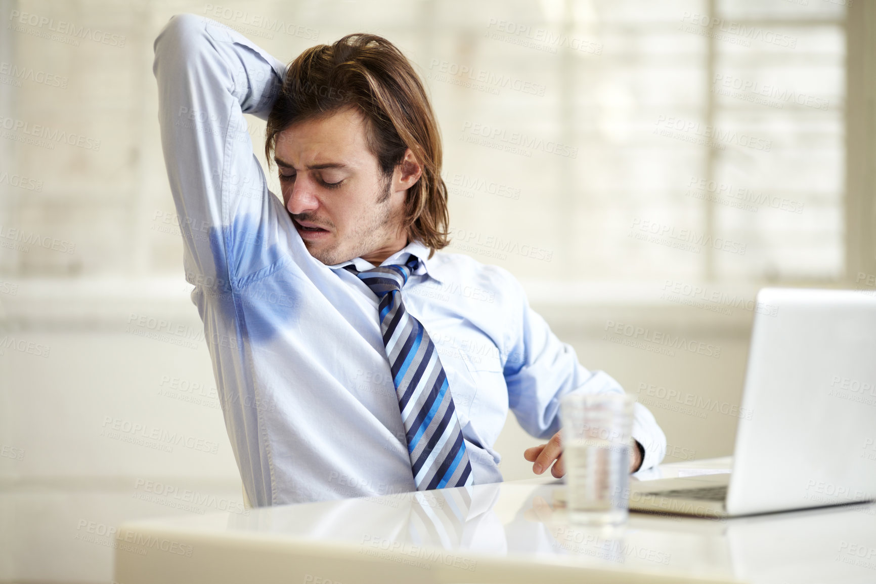 Buy stock photo Businessman, armpit and sweat smell at work for company employee stress, stink hygiene or bad stain. Male person, laptop and arm up for cleanliness mistake fail or frustrated, or wet shirt in office