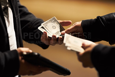 Buy stock photo Hands holding cash and a gun passing money between them