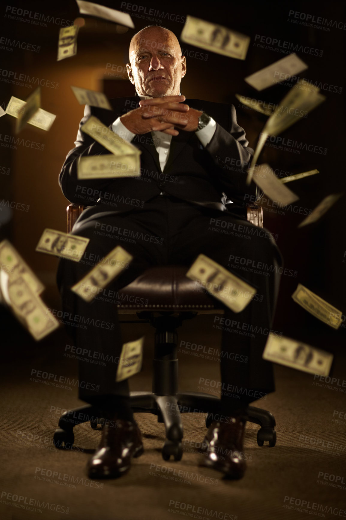 Buy stock photo Mob boss seated on a chair with banknotes blowing all around him