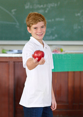 Buy stock photo Portrait, education and apple with a boy student in a classroom for learning, growth or development. Smile, kids and a happy young child in a class at school to study with a healthy fruit snack