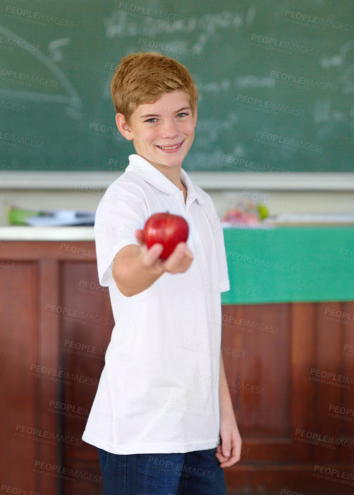 Buy stock photo Portrait, education and apple with a boy student in a classroom for learning, growth or development. Smile, kids and a happy young child in a class at school to study with a healthy fruit snack