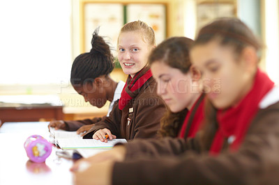 Buy stock photo Row of high school students sitting in the classroom