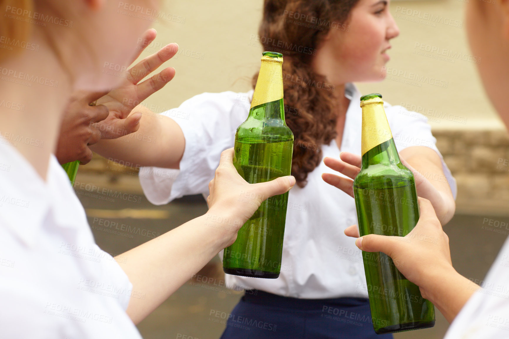 Buy stock photo Young female student turning down alcohol in response to peer pressure