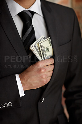 Buy stock photo Cropped shot of a man tucking a wad of cash into his jacket