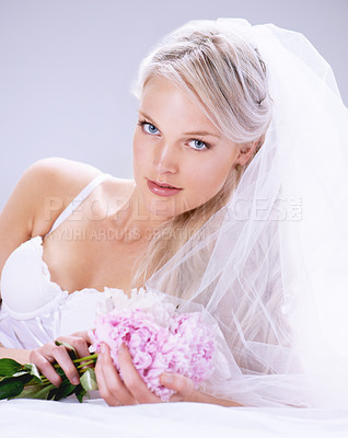 Buy stock photo Portrait, woman and bride with bouquet, lingerie and beauty with celebration on a white studio background. Person, model and girl with flowers, underwear and veil with plants, luxury and marriage