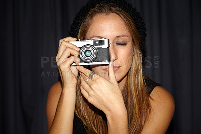 Buy stock photo Woman, vintage camera and photographer in dark background, picture and hipster. Serious, youth and hobby with photography, perspective planning and eyes closed, creative and cool with mockup space
