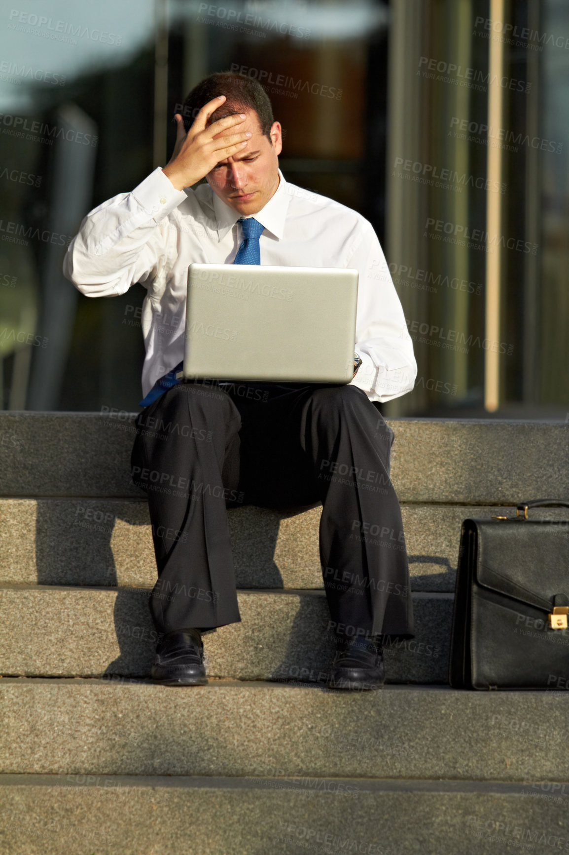 Buy stock photo Laptop, outdoor and business man stress, worry and sad for job fail, online mistake or news, bankruptcy and financial crisis. Person headache, debt and stock market crash on city stairs and computer