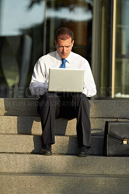 Buy stock photo Accounting, businessman with laptop and focus on staircase for remote work. Online communication or connectivity, deadline or social networking and serious or worried man working on financial report