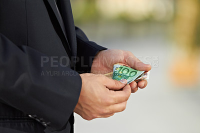 Buy stock photo Cropped image of a businessman's hands counting cash