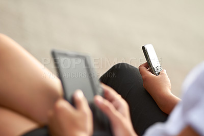 Buy stock photo Cropped image of two students, one with a digital tablet and one with a cellphone
