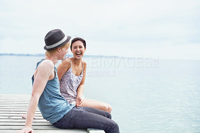 Buy stock photo Lake, happy and couple with feet in water laughing together for bonding, relax and relationship. Dating, travel and man and woman talking and sitting on dock for holiday, vacation and weekend break 