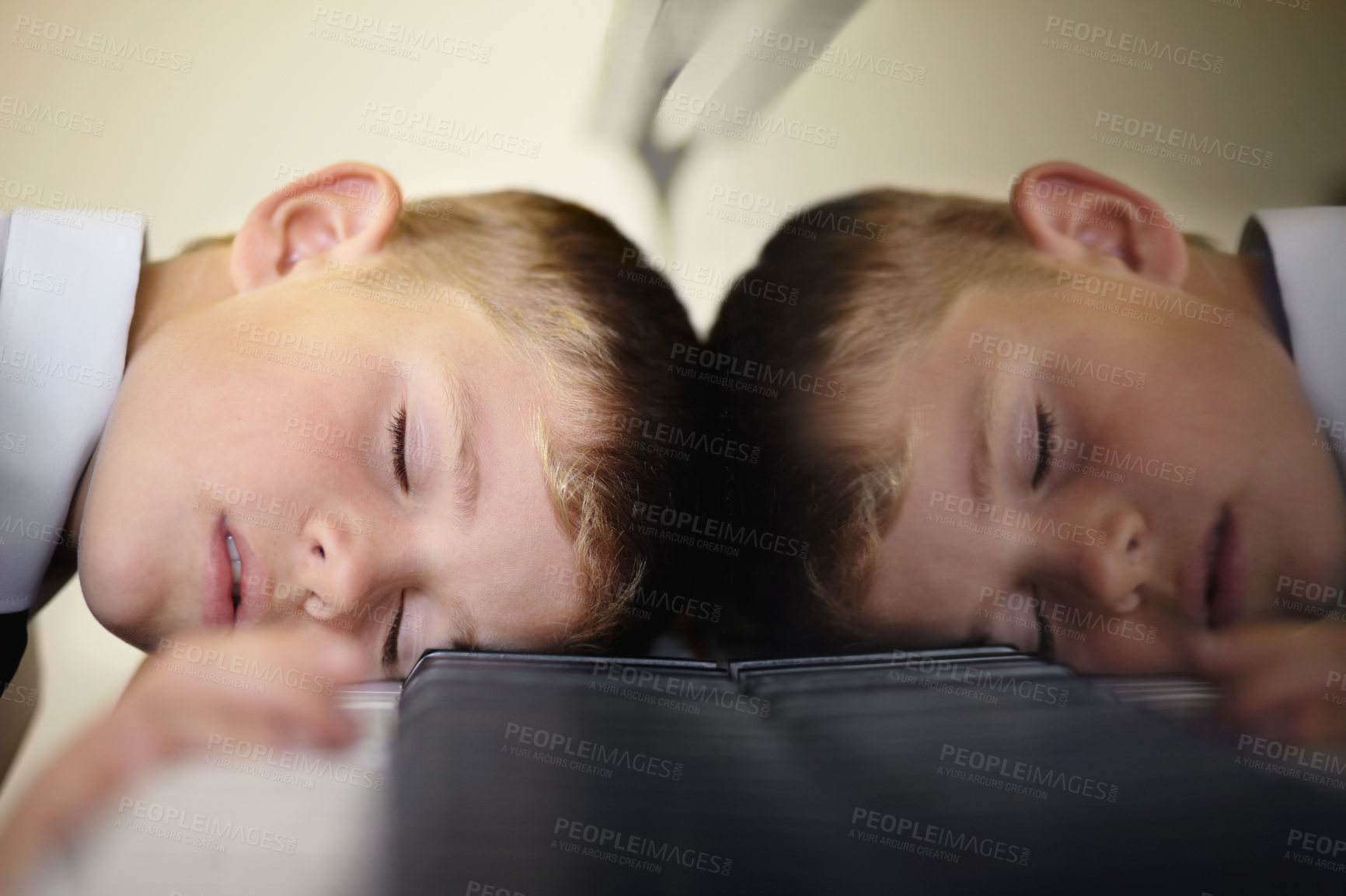 Buy stock photo Young piano student fast asleep on the keys of his piano