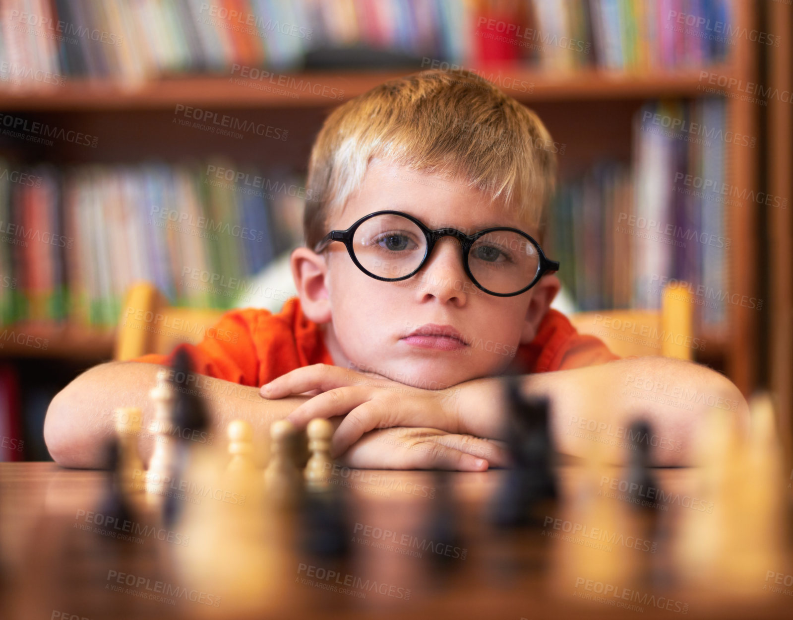 Buy stock photo Chess, thinking or bored with a boy student learning how to play a boardgame at school for education. Face, strategy and glasses with a young student child in a classroom for intelligence development