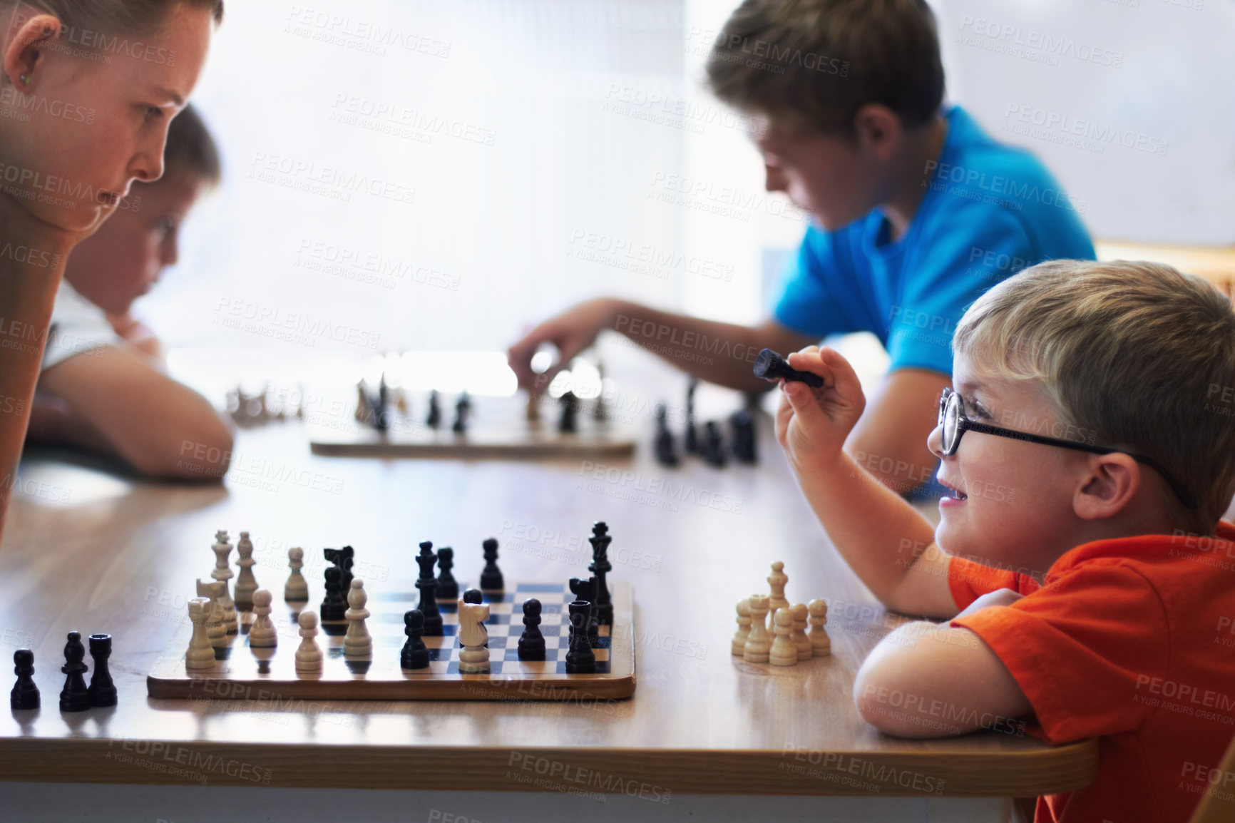Buy stock photo Students, chess and playing in a classroom, conversation and thinking with solution, problem solving and competition. Youth, group or boys with tournament, board game and strategy with skills or talk