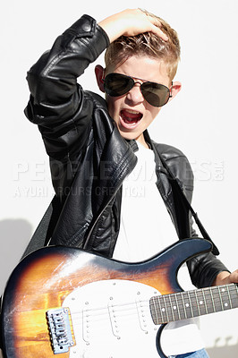 Buy stock photo Rock, portrait and child with guitar for creative sound, playing audio and cool young musician in sunglasses. Music, art and boy in performance, talent show for hipster children and white background.