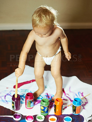 Buy stock photo Creative, drawing and baby with paint on paper for child development, fun and learning. Childhood, painting and young kid with colors for creativity, artwork and education for motor skills in home