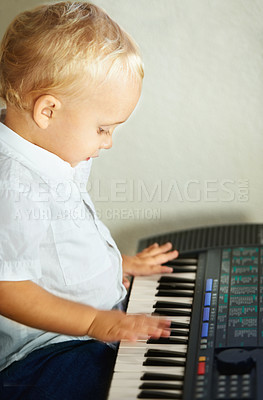 Buy stock photo Cute little boy playing the piano by himself - copyspace