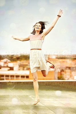 Buy stock photo Pretty young woman dancing whimsically on a rooftop