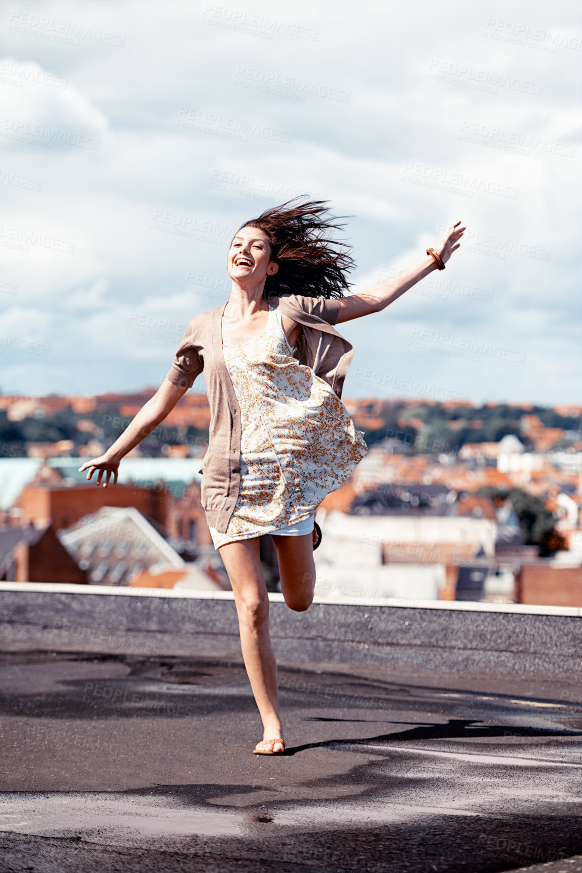 Buy stock photo Pretty young woman dancing whimsically on a rooftop