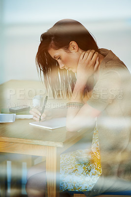 Buy stock photo Woman, thinking and writing in notebook by desk, coffee shop and learning summary in gen z aesthetic. Young, student and idea on paper with pen, planning and textbook with college project research

