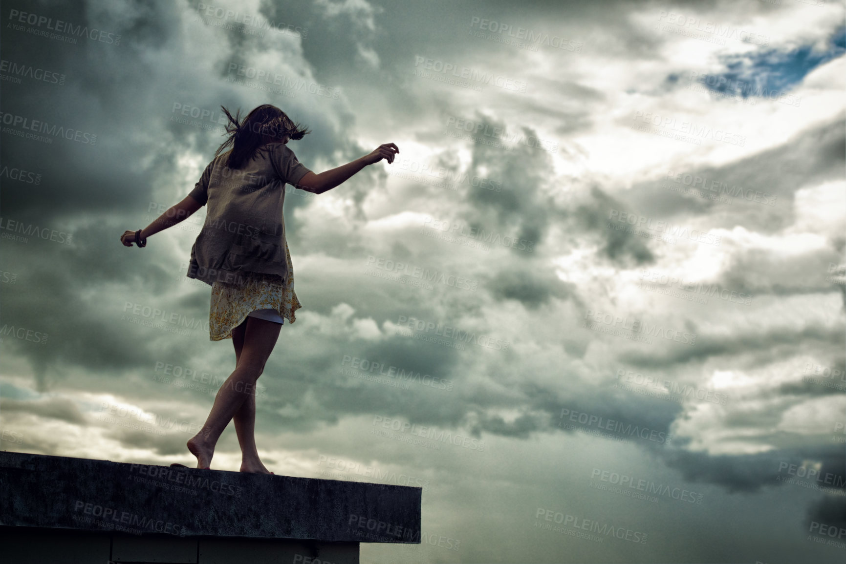Buy stock photo Woman, walking and balance on rooftop edge, freedom and fun by sky background, carefree and cloudy storm. Female person, back and travel or adventure, mental health and holiday or vacation
