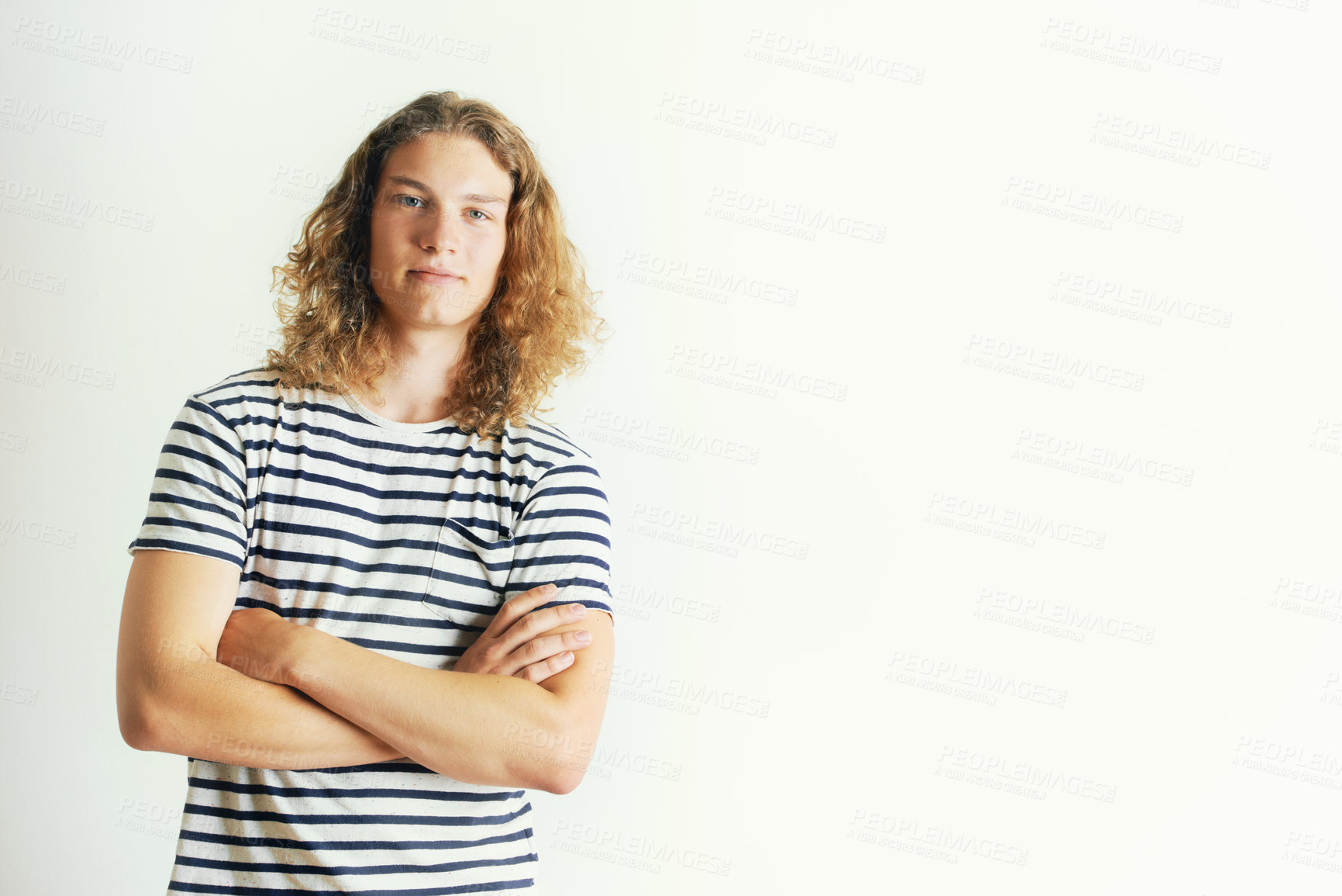 Buy stock photo Young man with curly long hair standing by himself