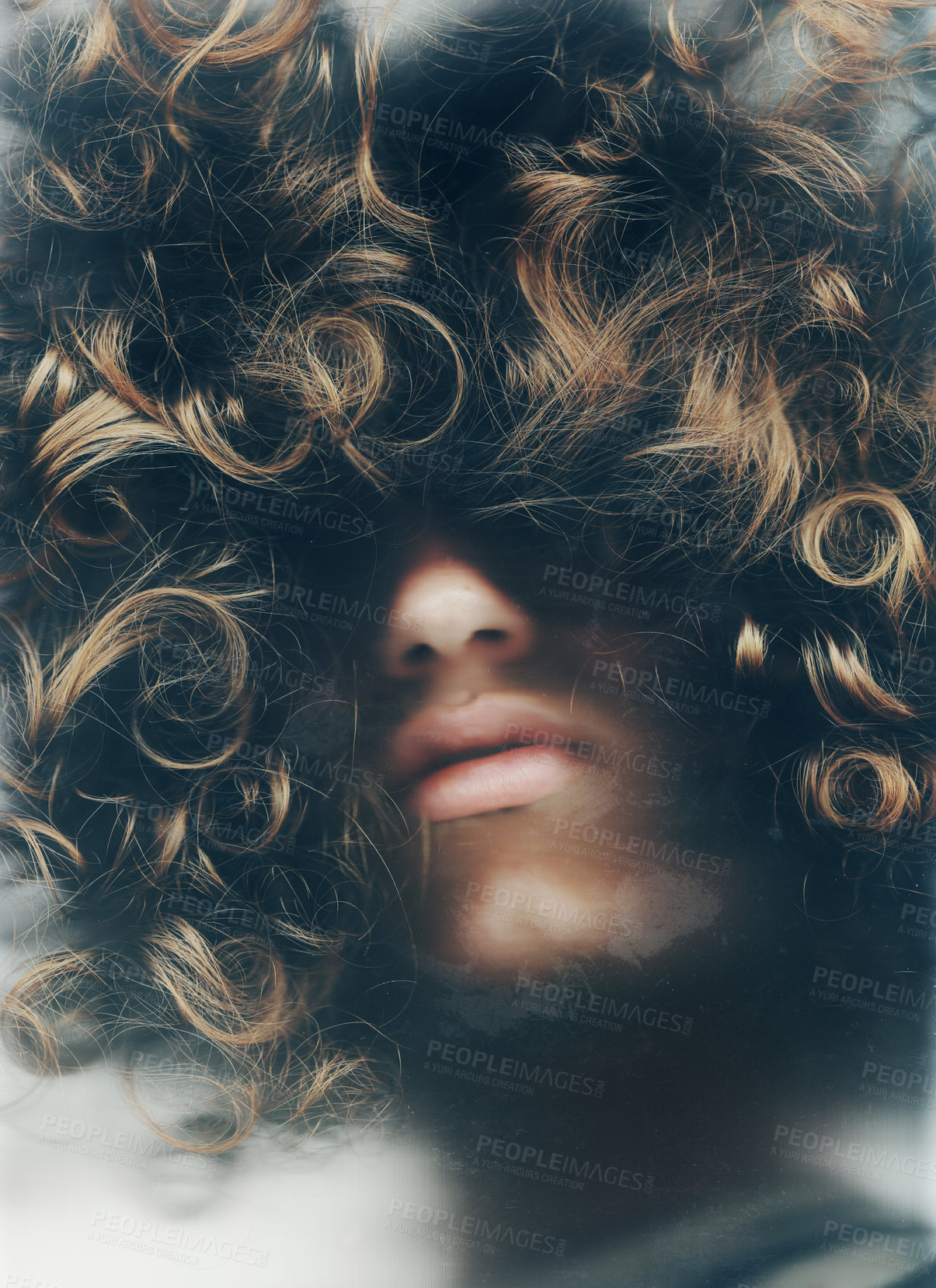 Buy stock photo Young man with his face obscured by his long, curly hair