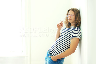 Buy stock photo Smoking, cigarette and portrait of man in home, apartment or relax in living room. Person, smoke and breathing with tobacco in house for calm feeling, cool aesthetic or model with a nicotine habit 