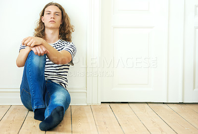 Buy stock photo Fashion, portrait and man on the floor in home with style of college student. Casual, person and relax on ground in apartment with jeans, tshirt and calm break in house on weekend and holiday