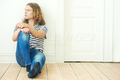 Buy stock photo Man, thinking and fashion for sitting on floor in home for looking, vision or peace. Sweden boy, male person and alone with idea for future by contemplating with curly hair, trendy or style for teen