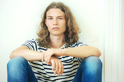 Buy stock photo Man, face and hair with beauty, trendy hipster with curly hairstyle and wellness. Young, gen z portrait and casual clothes with curls, style and serious in tshirt, cool person and relax with fashion