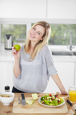 Buy stock photo Happy young woman making healthy food choices at home