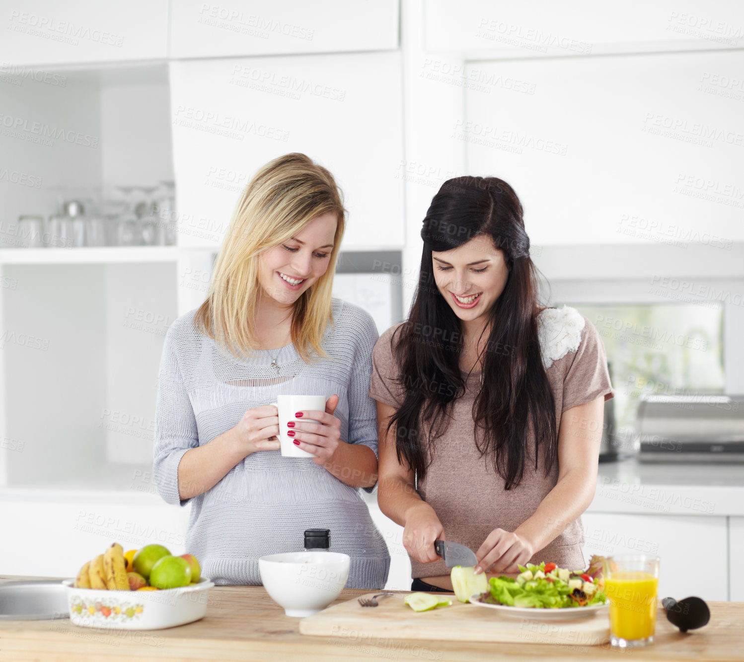 Buy stock photo Food, friends and women in a kitchen with salad, vegetables and bonding in their home together. Fruit, vegetarian and females preparing healthy snack for lunch, talking and happy in their apartment 