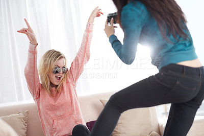 Buy stock photo Crazy women friends with a photography camera in happiness together and being silly in a home living room. Fun, people and photographer take pictures of a happy female person celebrating