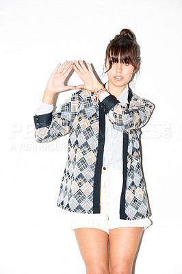 Buy stock photo Portrait, woman and triangle hand sign at studio isolated on a white background. Palm, pyramid and model frame fingers, symbol for diamond or fashion clothes, style and trendy hipster or cool person