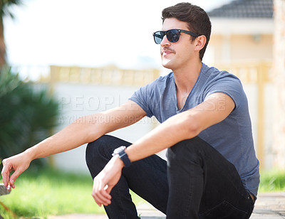 Buy stock photo Man in sunglasses, sitting with cigarette or thinking, relax outdoor and fashion at backyard of home or house. Smoking, cool person in glasses or style, trendy and hipster in casual clothes or tshirt