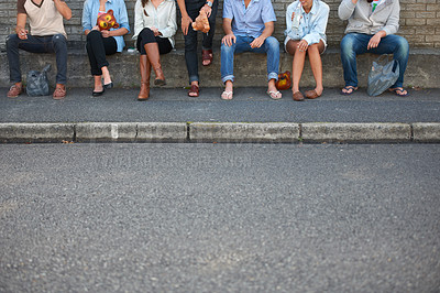 Buy stock photo Cropped view of young hipster friends seated outdoors
