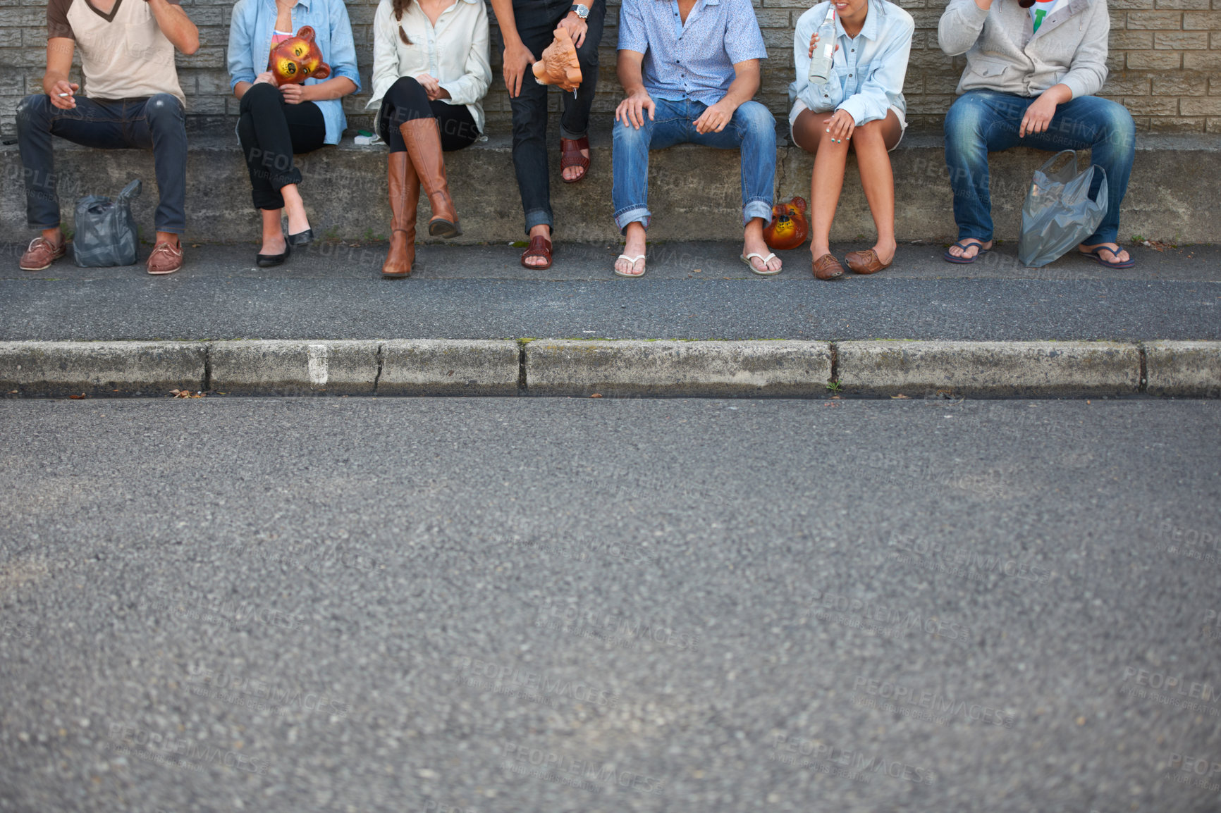 Buy stock photo Cropped view of young hipster friends seated outdoors