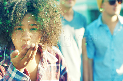 Buy stock photo Young woman blowing away a handful of glitter