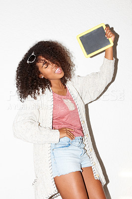 Buy stock photo Crazy, cool and a black woman with a blackboard for an announcement, marketing or advertising. Happy, fashion and an African girl with a chalkboard for information, message or a sign on a wall