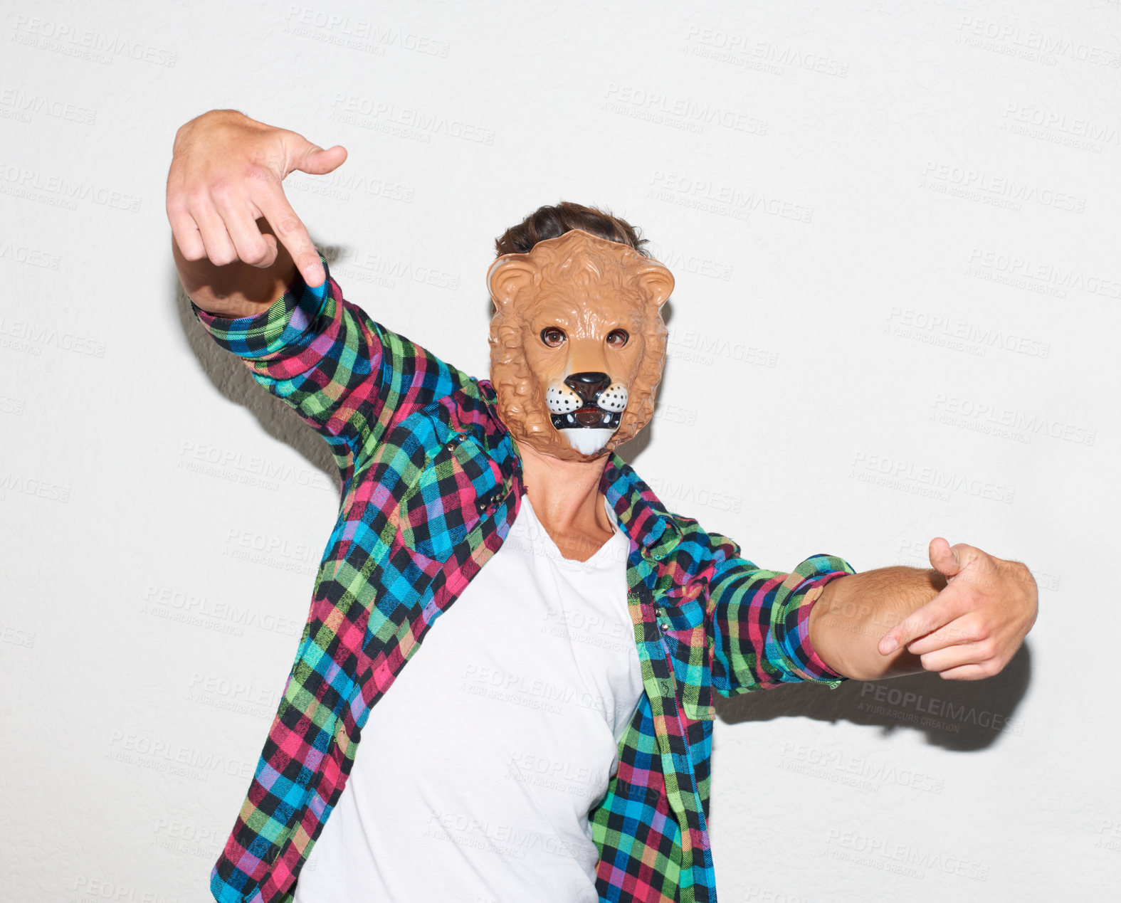 Buy stock photo Animal mask, hand gesture and a man in studio with cool attitude to party with a positive mindset. Lion face or male model person isolated on a white background for fun, funny and goofy portrait