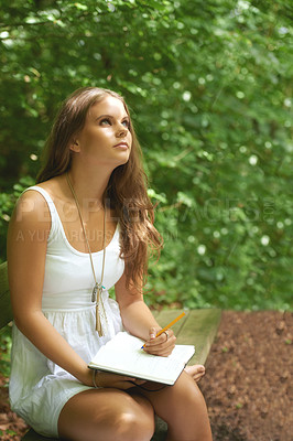 Buy stock photo Park, thinking and a woman writing in a journal outdoor during summer for mental health or expression. Creative, diary and peace with a young person in a green garden to relax for wellness or freedom