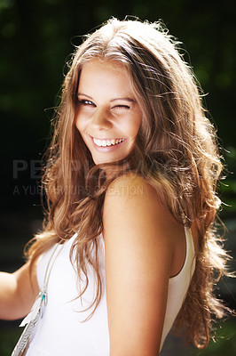 Buy stock photo Portrait, wink and smile with a woman in the countryside for freedom, summer travel or to relax. Face, park and nature with happy young person in the forest or woods for wellness or friendly flirting