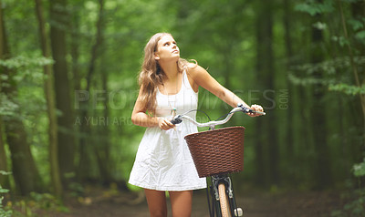 Buy stock photo Bike, basket and a woman walking in the forest for travel, freedom or adventure in nature during spring. Thinking, relax and a young person pushing her bicycle in the countryside for peace or quiet