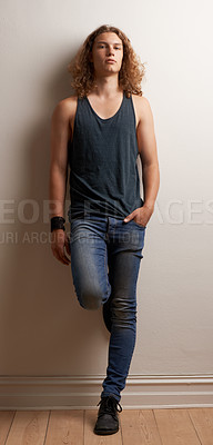 Buy stock photo Stylish, portrait and a man in fashion on a wall for urban style, cool and confident in a house. Model, sexy and a young person in trendy, edgy and hipster clothes, looking handsome and fashionable