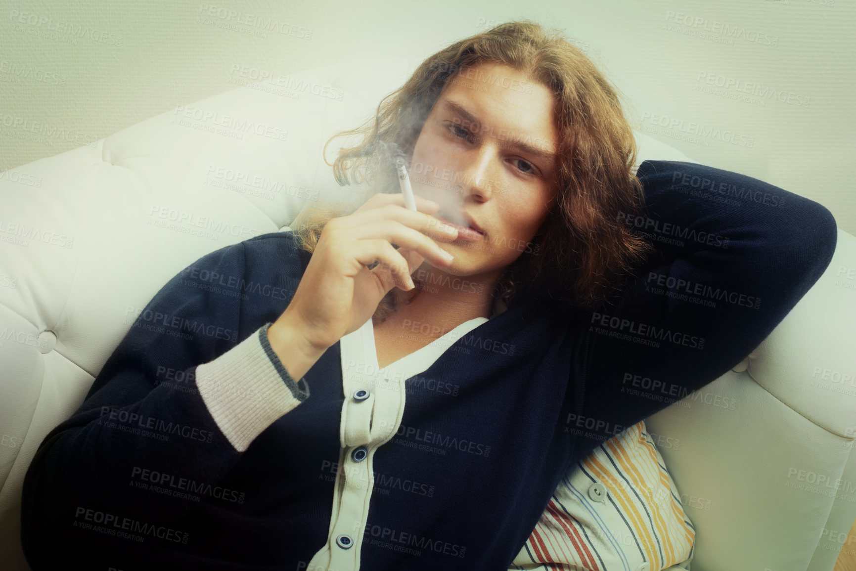 Buy stock photo Portrait of a handsome young man smoking a cigarette