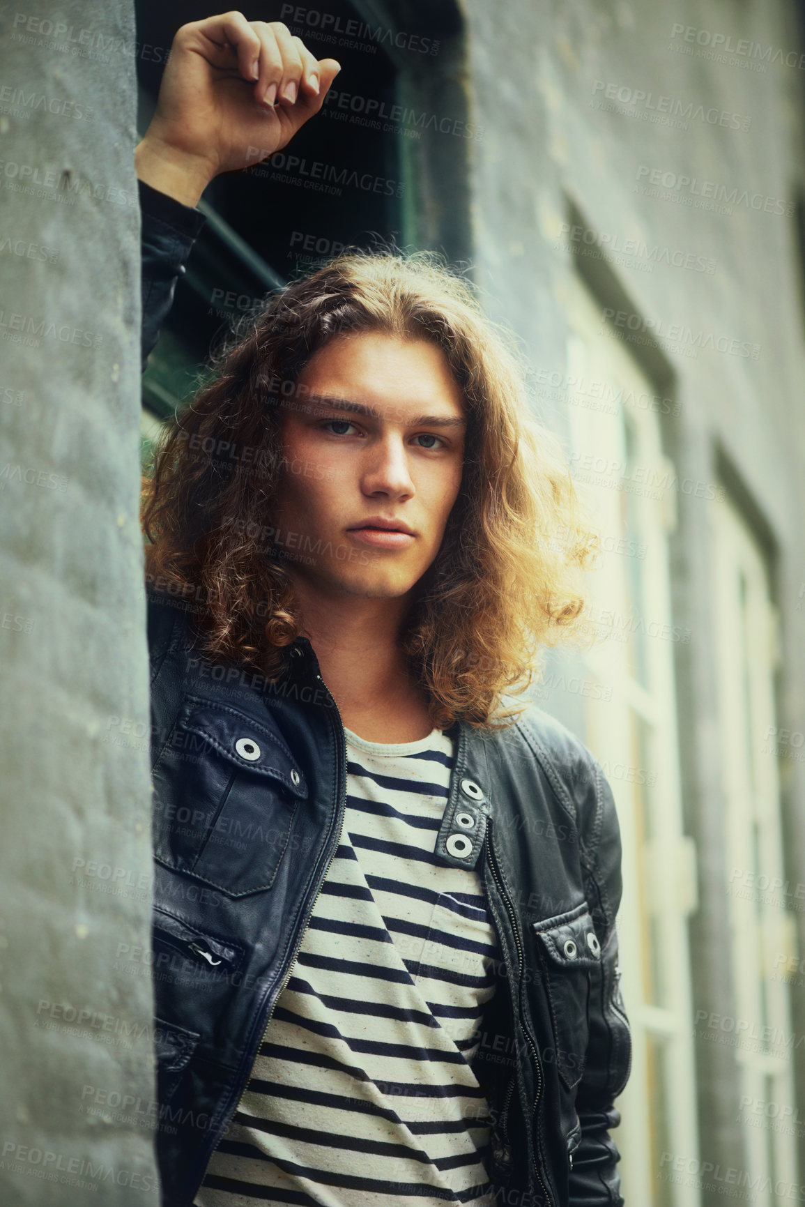 Buy stock photo Portrait, fashion and a man on a wall in the city during summer for travel or tourism in the afternoon. Street, cool and confident young model leaning on a building in an urban town for trendy style