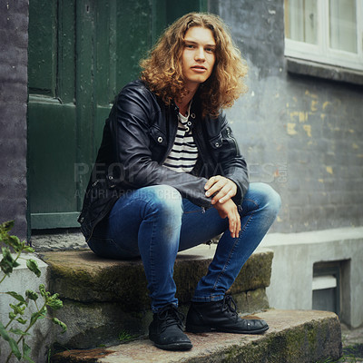 Buy stock photo Man, fashion and portrait or leather jacket rebel or trendy style, clothes or denim jeans. Male person, model and face sitting outdoor step for edgy look or cool confidence, rocker or doorway brick