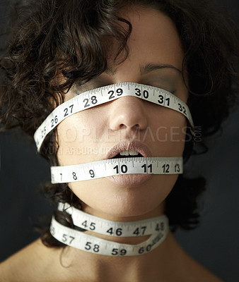 Buy stock photo Anorexia, tape and suffering with face of woman for eating disorder, weight loss and fear. Diet, frustrated and mental health with female measuring size for anxiety, stress and bulimia problem